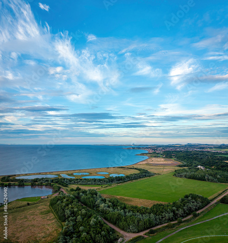 Aerial view of lagoons, green fields, and trees in Windsor Park, Musselburgh, Scotland, United Kingdom. photo