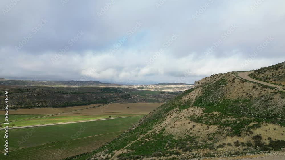 Lateral drone flight over the top of a hill where the remains of a tower and a section of the wall of a 14th century castle appear. There is a great view in Huete in the province of Cuenca. Lateral drone flight over the top of a hill where the remains of a tower and a section of the wall of a 14th century castle appear. There is a great view in Huete in the province of Cuenca.