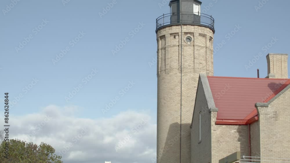 Old Mackinac Point Lighthouse in Mackinaw City, Michigan with cinematic video shot on dolly to reveal Mackinac Bridge and white picket fence. Old Mackinac Point Lighthouse in Mackinaw City, Michigan with cinematic video shot on dolly to reveal Mackinac Bridge and white picket fence.