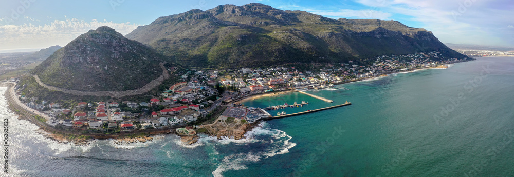 Aerial view of coastal town with harbour, ocean, and hills, Cape Town, South Africa.