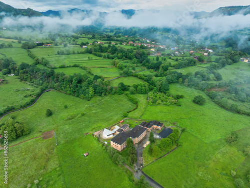 Wallpaper Mural Aerial view of lush greenery fields, forest, and mountains in rural Infiesto, Asturia, Spain. Torontodigital.ca