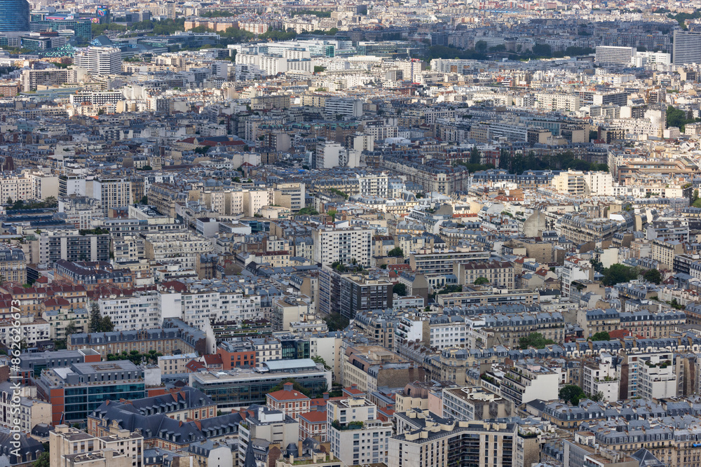 Aerial view of dense, crowded Paris with residential and commercial buildings, streets, and rooftops, Ile de France, France. Aerial view of dense, crowded Paris with residential and commercial buildings, streets, and rooftops, Ile de France, France.