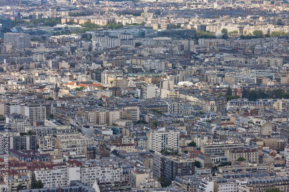Aerial view of dense, crowded Paris with residential and commercial buildings, rooftops, streets, and roads, Ile de France, France. Aerial view of dense, crowded Paris with residential and commercial buildings, rooftops, streets, and roads, Ile de France, France.