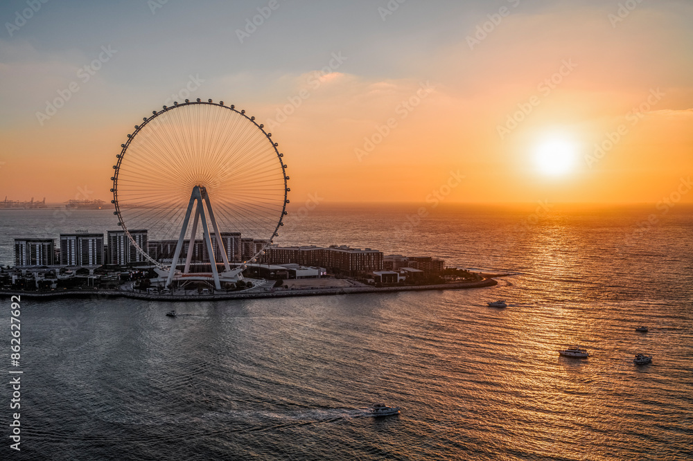 Aerial view of Dubai Marina with Ain Dubai Ferris wheel at sunset, United Arab Emirates. Aerial view of Dubai Marina with Ain Dubai Ferris wheel at sunset, United Arab Emirates.