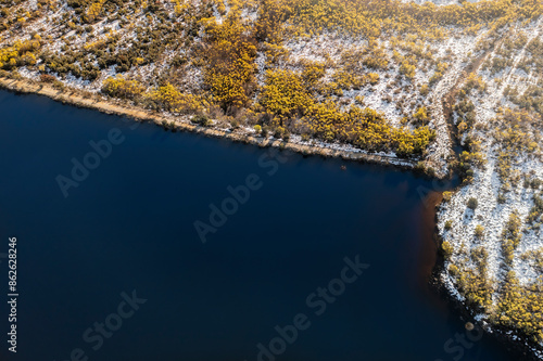 Aerial view of vibrant autumn lake surrounded by golden foliage and serene shoreline, Ceres, South Africa. photo