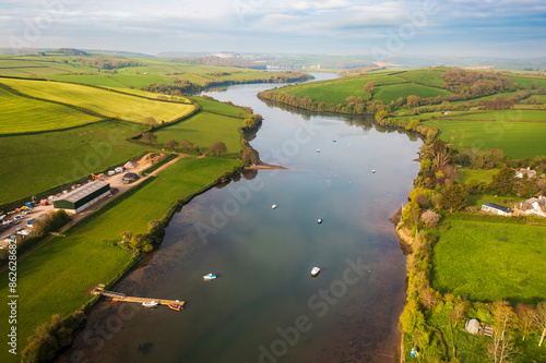 Aerial view of serene countryside with river, boats, rolling hills, and green fields, Frogmore, England. photo