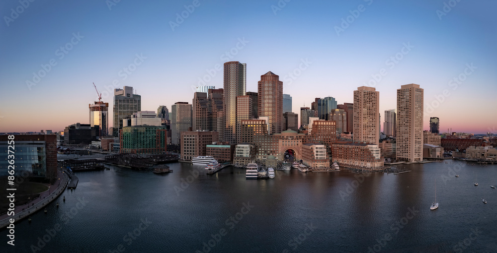 Aerial view of urban skyline at sunset with waterfront and harbor, Boston, Massachusetts, United States. Aerial view of urban skyline at sunset with waterfront and harbor, Boston, Massachusetts, United States.