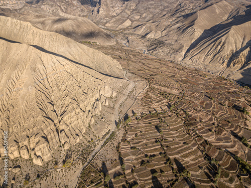 Aerial view of majestic mountains and terrace farming in Ghami village, Mustang, Nepal. photo