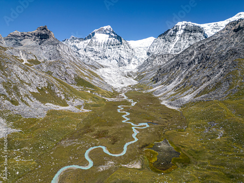 Aerial view of Chandi mountain in serene valley with snow-covered mountains and glacier, Gamghadi, Mugu, Nepal. photo