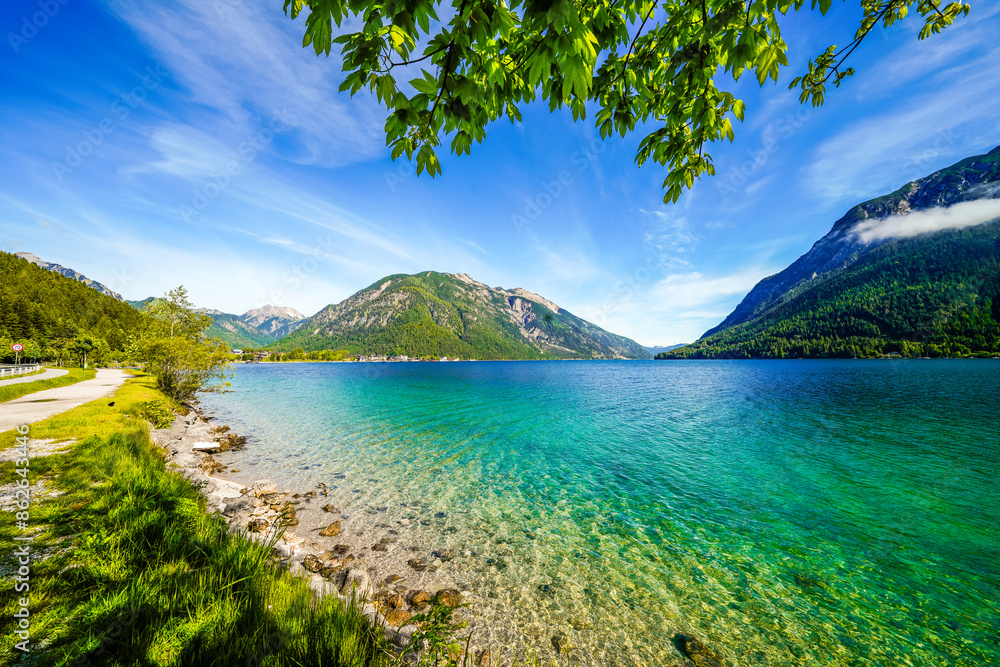 Fototapeta premium View of Lake Achensee in Tyrol. Nature at the turquoise lake and a mountain landscape in the background. Achental in Austria. 