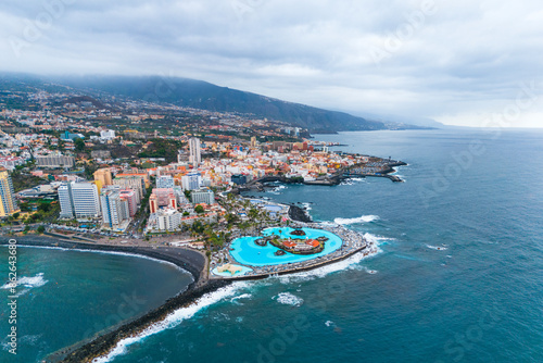 Aerial drone view of Puerto de la Cruz, coastal city and waterpark Martianez on the North of Tenerife island, Spain photo