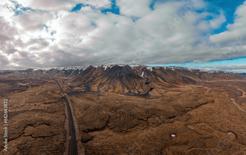 Aerial view of majestic volcanic mountain landscape with road under dramatic sky, Hafnarfjordur, Iceland. photo