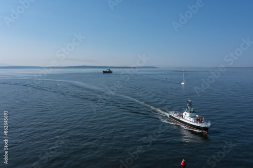 Wallpaper Mural Aerial view of Fishing Boat in Puget Sound with serene shoreline and blue sky, Seattle, Washington, United States. Torontodigital.ca