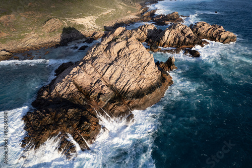 Aerial view of rugged cliffs and waves at Sugarloaf Rock, Cape Naturaliste, Australia. photo