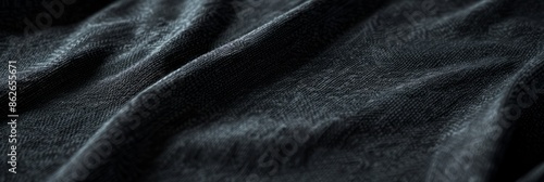 Close-up photo of black t-shirt sleeve mockup, emphasizing soft textured fabric details