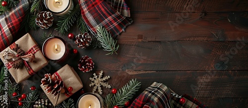 Christmas flat lay style arrangement of vintage gift boxes, candles, and a tartan scarf with a free text space image. Copy space image. Place for adding text and design