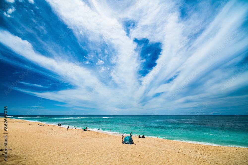 View of Sunset Beach with sandy shore, azure ocean, and picturesque clouds, Hawaii, United States. View of Sunset Beach with sandy shore, azure ocean, and picturesque clouds, Hawaii, United States.
