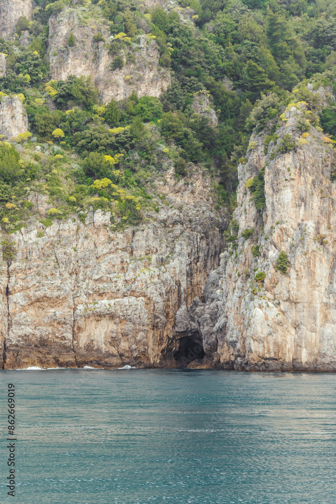 View of cliffs and water with rocks and cave, Amalfi Coast, Italy. View of cliffs and water with rocks and cave, Amalfi Coast, Italy.