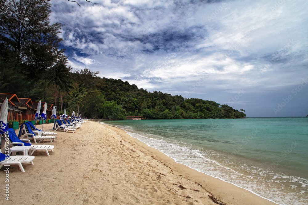 View of Patong beach and Andaman sea with chairs, umbrellas, and trees, Phuket Island, Thailand. View of Patong beach and Andaman sea with chairs, umbrellas, and trees, Phuket Island, Thailand.
