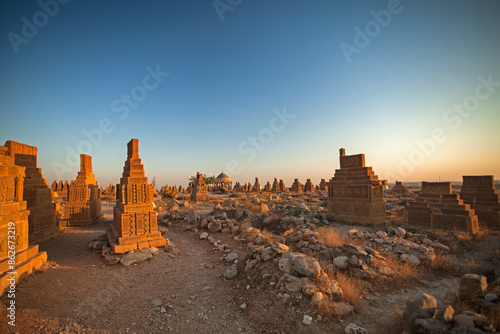 View of Chaukhandi tombs at sunset in rocky terrain, Karachi, Pakistan.