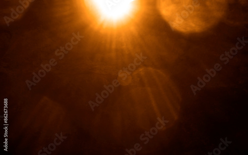 blurred image. shiny sun, sunbeams, sunrays, sunshine design. Yellow orange warm light effect, sun rays, golden beams isolated on black background. star dust photo