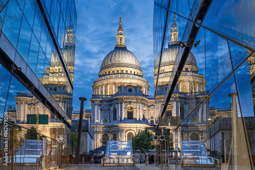 Illuminated Saint Paul`s Cathedral and its reflections in the windows during the blue hour, London, the United Kingdom photo