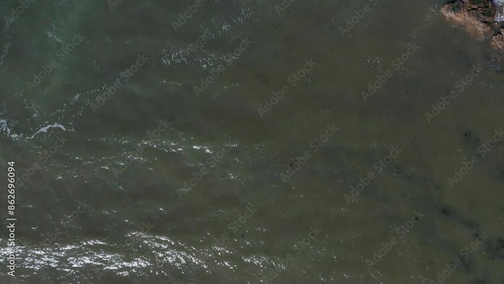 Aerial view of rocky shoreline and ocean waves at East Beach, North Berwick, Scotland. Aerial view of rocky shoreline and ocean waves at East Beach, North Berwick, Scotland.