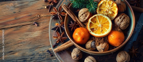 Rustic style bowl with winter food elements like nuts, oranges, cinnamon, and star anise, creating a cozy atmosphere with copy space image. photo