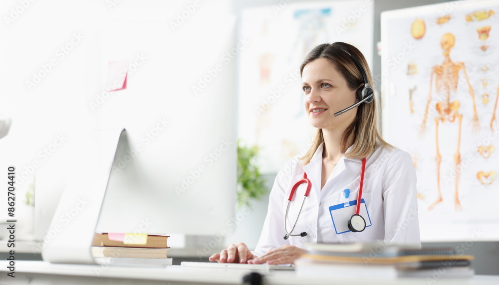 Smiling female doctor consultant in headphones is providing medical assistance remotely. Provision of medical services in coronavirus pandemic concept Smiling female doctor consultant in headphones is providing medical assistance remotely. Provision of medical services in coronavirus pandemic concept