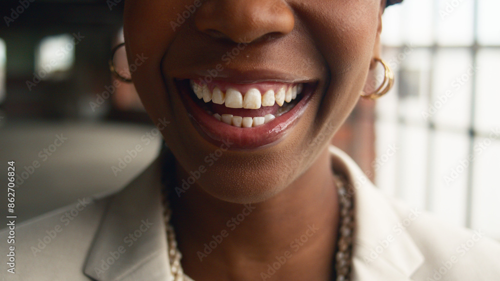 Close-Up of Smiling Woman in Modern Industrial Setting with Bright Natural Light Close-Up of Smiling Woman in Modern Industrial Setting with Bright Natural Light