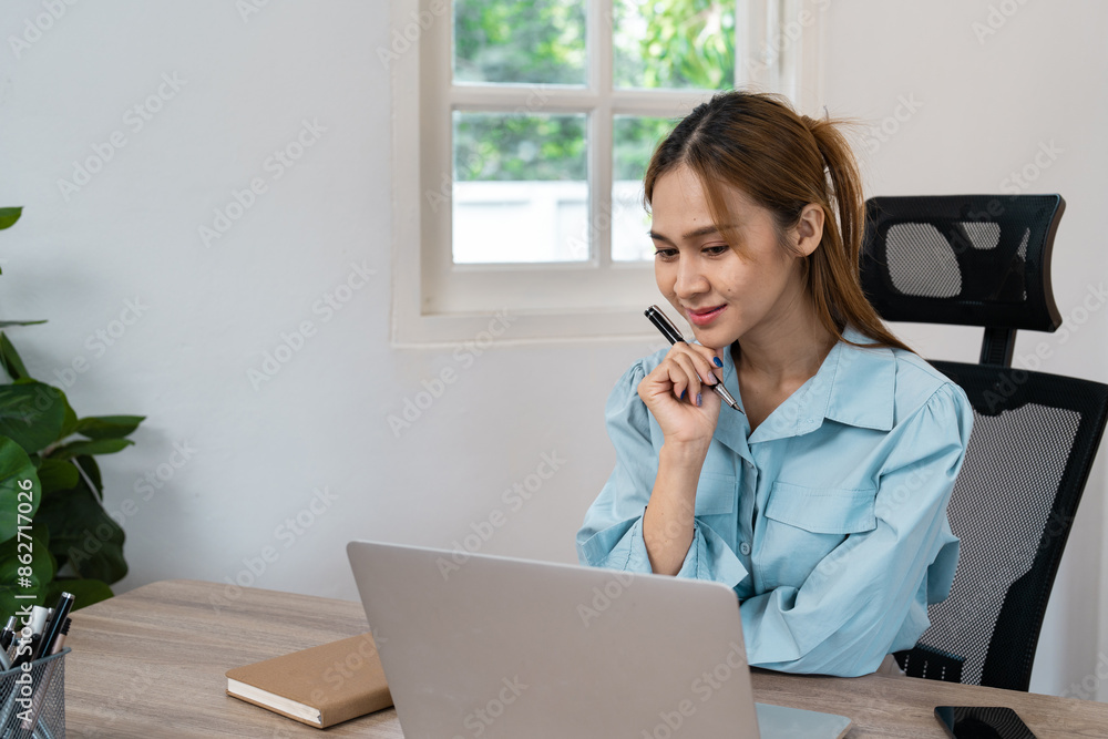 Young Professional Woman Working Remotely from Home Office with Laptop and Notebook Young Professional Woman Working Remotely from Home Office with Laptop and Notebook
