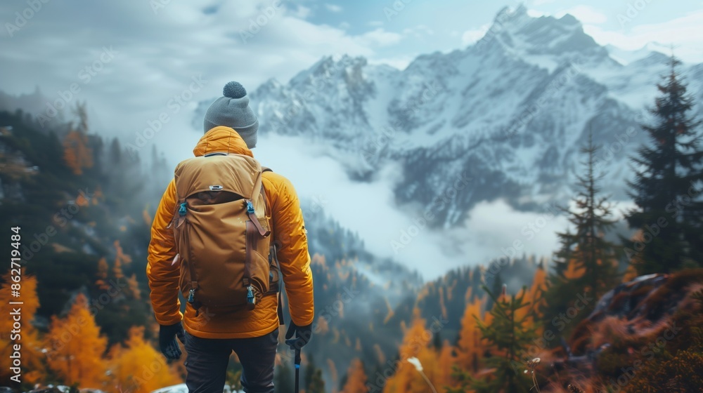 Backpacker Admires Snowy Mountain View in Autumn Backpacker Admires Snowy Mountain View in Autumn