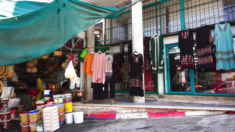 Naklejka premium Colorful Traditional Clothing Outdoor Market Storefront Wide Photo