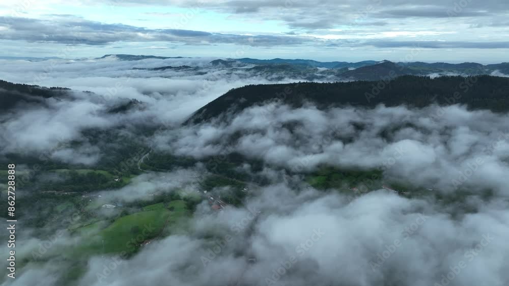 Aerial view of misty, foggy valley with lush greenery and serene mountains, Infiesto, Asturias, Spain. Aerial view of misty, foggy valley with lush greenery and serene mountains, Infiesto, Asturias, Spain.
