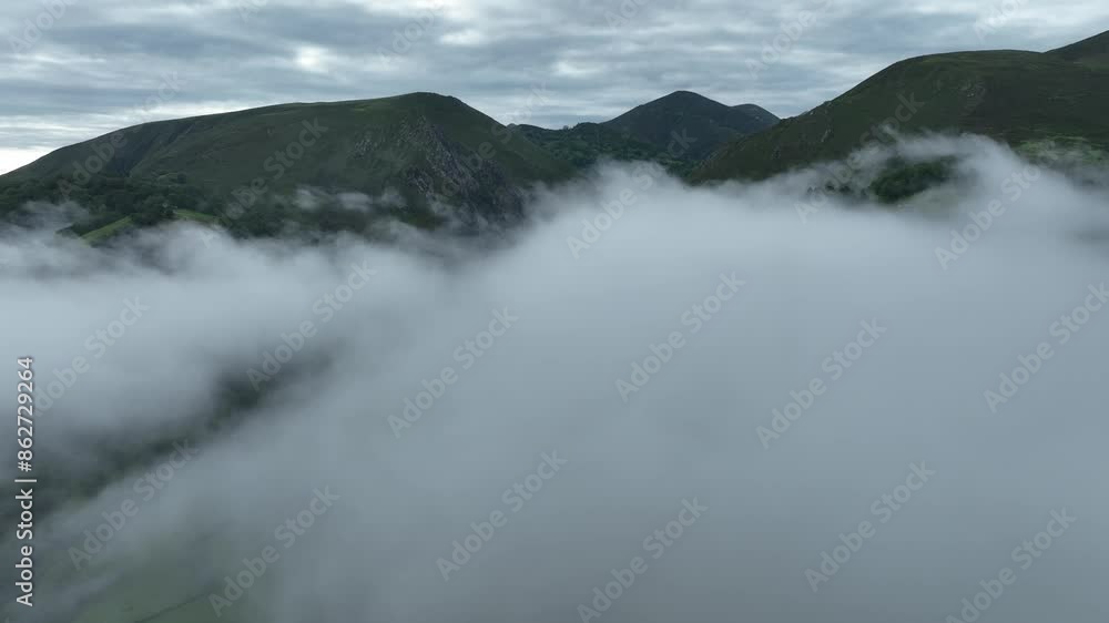 Aerial view of misty mountains and lush valley in Infiesto, Asturias, Spain. Aerial view of misty mountains and lush valley in Infiesto, Asturias, Spain.