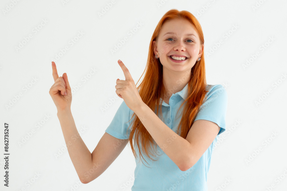 Hey look. Smiling pretty female model pointing fingers left at empty space and inviting to check it out, showing advertisement on white background. Hey look. Smiling pretty female model pointing fingers left at empty space and inviting to check it out, showing advertisement on white background.