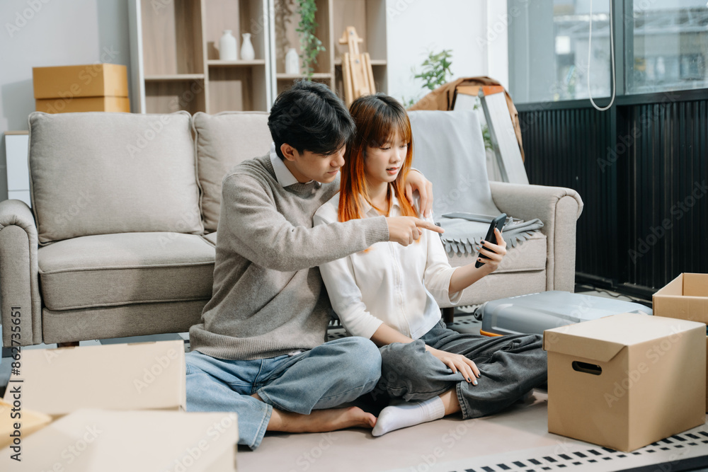 Happy asian young attractive couple man and woman with big boxes moving into a new house, new apartment Happy asian young attractive couple man and woman with big boxes moving into a new house, new apartment