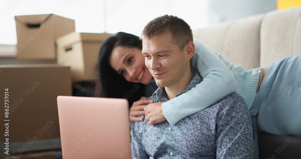 Woman hugs man against background of boxes in an apartment. Rent and purchase of housing concept Woman hugs man against background of boxes in an apartment. Rent and purchase of housing concept
