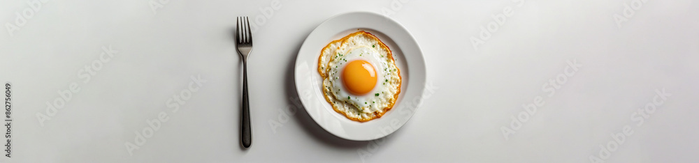 Fried egg on white plate isolated on white background, fried egg with runny yolk on white plate, isolated on white background, Design template for Poster, Web banner, Brochure, Card with copy space