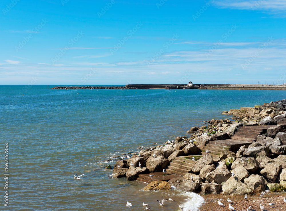 A view from Gun Cliff walkway back towards the harbour at Lyme Regis Dorset on a sunny summer morning A view from Gun Cliff walkway back towards the harbour at Lyme Regis Dorset on a sunny summer morning