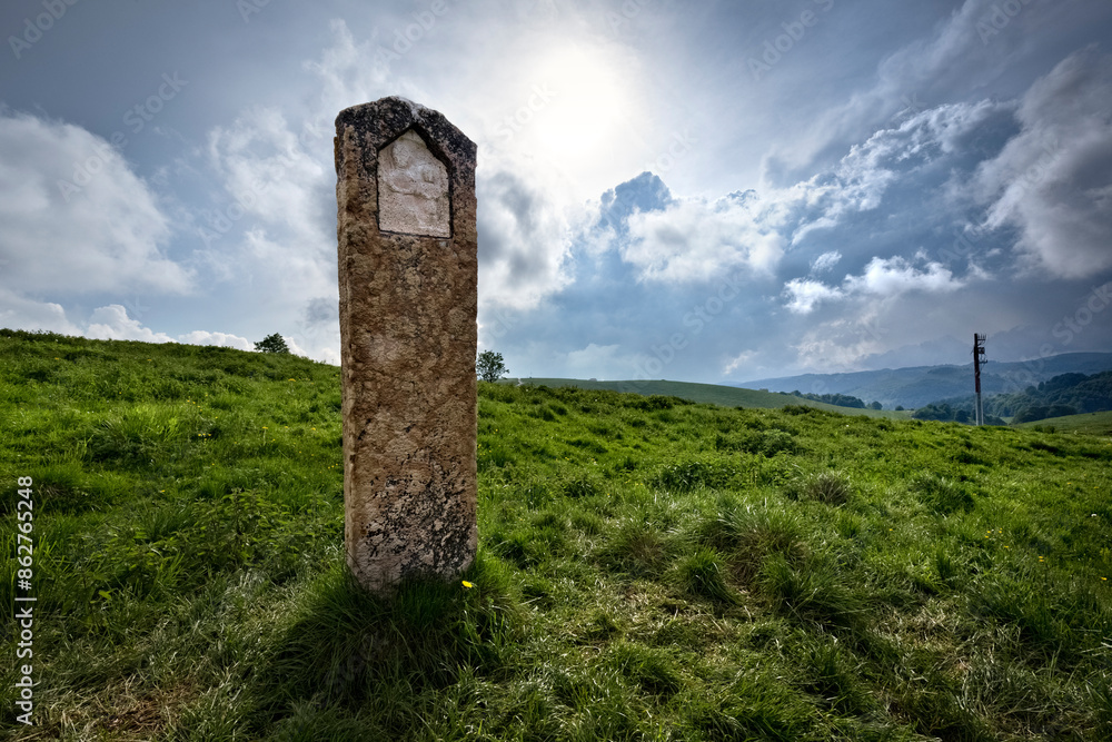 Religious stone with bas-relief among the pastures of Lessinia. Velo Veronese, Veneto, Italy.