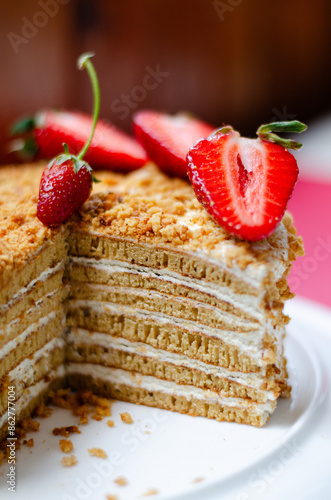 Crepe cake Medovik with sour cream vanilla cream and strawberries. Pancake cake Medovik decorated with strawberries.