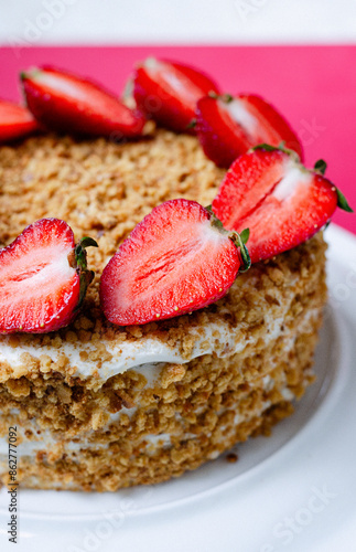 Crepe cake Medovik with sour cream vanilla cream and strawberries. Pancake cake Medovik decorated with strawberries.