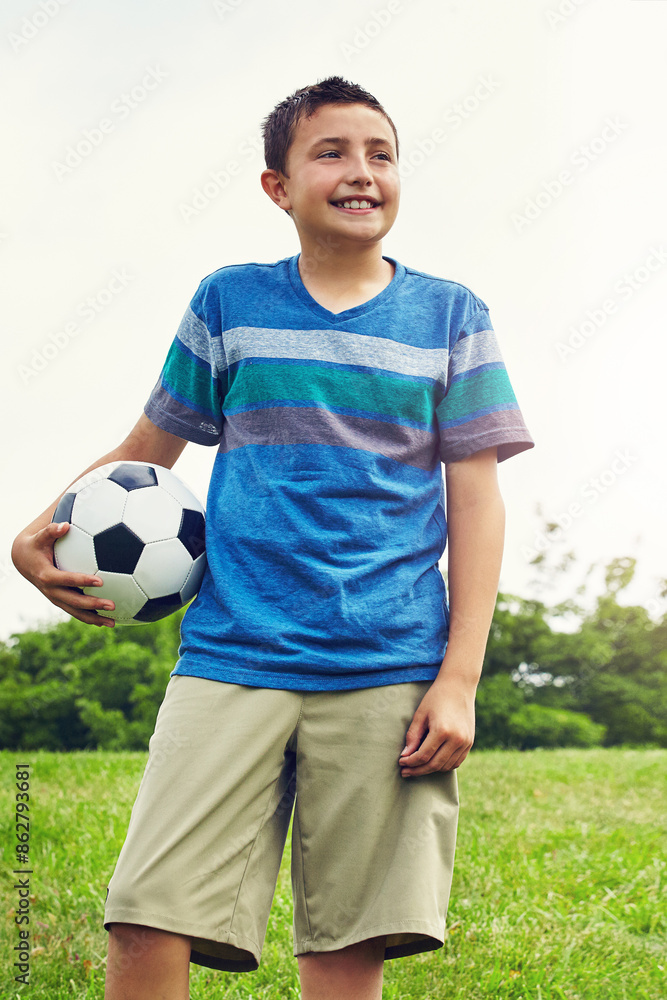 Nature, thinking and boy child with soccer ball in outdoor park for development, idea or hobby. Grass, sports and young kid with smile in playground for happiness, solution or football game in Canada Nature, thinking and boy child with soccer ball in outdoor park for development, idea or hobby. Grass, sports and young kid with smile in playground for happiness, solution or football game in Canada