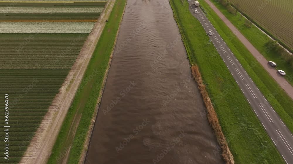 Aerial view of tulip fields and Noordhollandsch Kanaal in spring, Sint Maartensvlotbrug, Netherlands. Aerial view of tulip fields and Noordhollandsch Kanaal in spring, Sint Maartensvlotbrug, Netherlands.