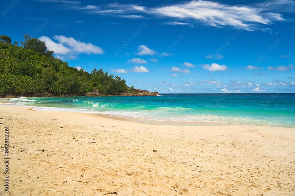 Anse Intendance beach, blue sky turquoise water, low tide with waves, sunny day, white sandy beach, Mahe, Seychelles Anse Intendance beach, blue sky turquoise water, low tide with waves, sunny day, white sandy beach, Mahe, Seychelles
