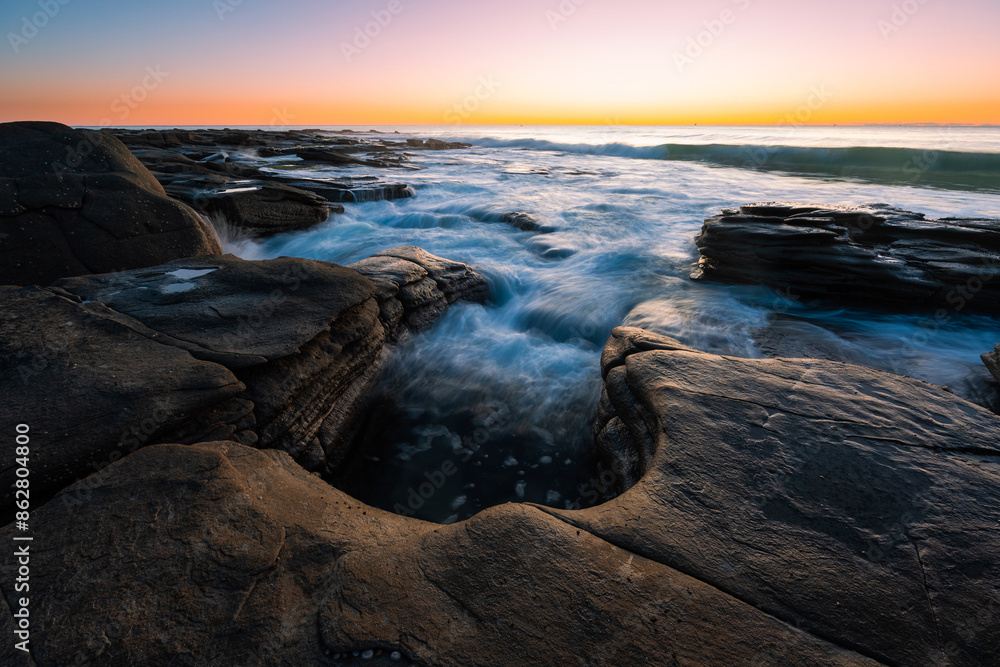 Beautiful sunrise sky over rocky coastline. Beautiful sunrise sky over rocky coastline.