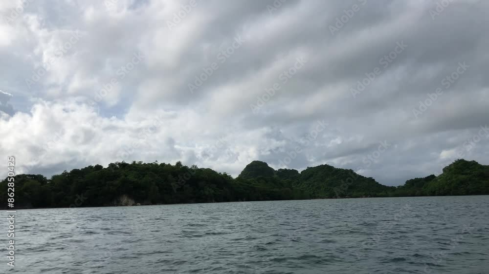 Beauty of a forested island with a captivating tracking shot from a moving boat Beauty of a forested island with a captivating tracking shot from a moving boat