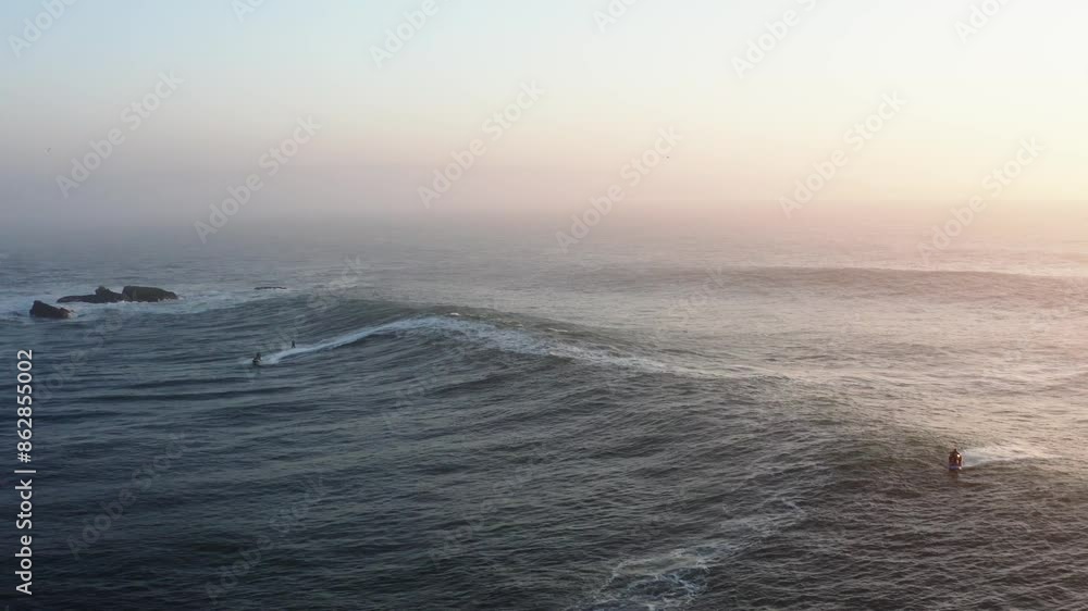 Aerial view of big waves and surfers in Nazare, Leiria, Portugal. Aerial view of big waves and surfers in Nazare, Leiria, Portugal.