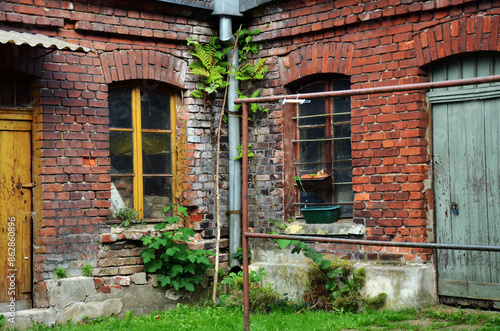 Old brick building of lumber rooms in the yard of workers houses